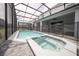 Enjoy the screened-in pool and spa, with easy access to the covered patio and backyard at 4189 Lana Ave, Davenport, FL 33897