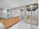 Bathroom features double sinks, marble floors, granite countertops, and glass shower with tiled diamond accents at 1110 W Ivanhoe Blvd # 6, Orlando, FL 32804