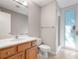 Bathroom with wood vanity, white sink, shower with glass door, toilet, and towel bar at 1110 W Ivanhoe Blvd # 6, Orlando, FL 32804