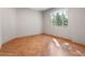 A bedroom with gray walls and hardwood floors, and a window overlooking greenery at 1110 W Ivanhoe Blvd # 6, Orlando, FL 32804