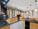 A spacious kitchen with granite counters, wood cabinets, and modern appliances at 1110 W Ivanhoe Blvd # 6, Orlando, FL 32804
