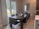 Elegant dining room with a large table and modern chairs at 7740 Sandy Ridge Dr # 217, Reunion, FL 34747