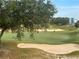 Golf course view with players putting on the green at 7740 Sandy Ridge Dr # 217, Reunion, FL 34747