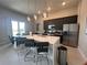 Modern kitchen with stainless steel appliances and island at 7740 Sandy Ridge Dr # 217, Reunion, FL 34747