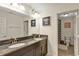 Bathroom with a double sink vanity featuring a granite countertop and a walk-in shower at 9149 Outlook Rock Trl, Windermere, FL 34786