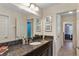 Bathroom featuring dark cabinets, granite countertop, and multiple doorways providing seamless flow at 9149 Outlook Rock Trl, Windermere, FL 34786