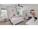 Charming bedroom decorated with soft colors, featuring a cozy bed, whimsical wall decor, and ample natural light at 9149 Outlook Rock Trl, Windermere, FL 34786