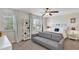 Bright bedroom with stylish decor featuring a comfortable bed, a cozy sofa, and plenty of natural light at 9149 Outlook Rock Trl, Windermere, FL 34786