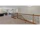 Open concept loft features a cozy seating area and a study space with natural light and custom shelving at 9149 Outlook Rock Trl, Windermere, FL 34786
