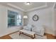 Bright living room features a cozy atmosphere with an oversized floor lamp, neutral paint, and wood flooring at 9149 Outlook Rock Trl, Windermere, FL 34786