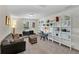 Spacious loft features modern decor, seating, and shelving with natural light from a nearby window at 9149 Outlook Rock Trl, Windermere, FL 34786
