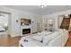 Cozy living room with a fireplace, built-in bookshelves, and staircase access at 9149 Outlook Rock Trl, Windermere, FL 34786