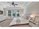 Inviting main bedroom features a ceiling fan, neutral paint, and ample natural light at 9149 Outlook Rock Trl, Windermere, FL 34786