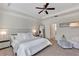 Spacious main bedroom with a ceiling fan, ensuite bathroom and ample natural light at 9149 Outlook Rock Trl, Windermere, FL 34786