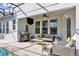 Covered patio with a grill, seating area, ceiling fan, and view of the pool at 9149 Outlook Rock Trl, Windermere, FL 34786