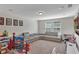 Spacious playroom with a large gray couch, a window, and lots of toys at 9149 Outlook Rock Trl, Windermere, FL 34786