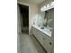 Bathroom featuring a double vanity, tiled floors, and separate tub and shower at 3219 Legends Preserve Dr, Daytona Beach, FL 32124