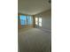 Bright bedroom features neutral carpet, beige walls, and two sunny windows providing ample natural light at 3219 Legends Preserve Dr, Daytona Beach, FL 32124