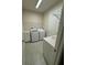 Tiled laundry room features side by side washer and dryer, sink, cabinets, and shelving for optimal organization at 3219 Legends Preserve Dr, Daytona Beach, FL 32124