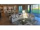 Spacious open-concept living area with a sofa, kitchen, and sliding glass doors to backyard at 3219 Legends Preserve Dr, Daytona Beach, FL 32124