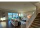 Bright living room features wood floors, neutral walls, and sliding glass doors leading to a beautiful outdoor view at 3219 Legends Preserve Dr, Daytona Beach, FL 32124