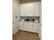Well-organized mud room features white cabinets, countertop space, and stylish decor accents at 3219 Legends Preserve Dr, Daytona Beach, FL 32124