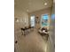 Bright home office with large windows, modern desk, and a comfortable seating area at 3219 Legends Preserve Dr, Daytona Beach, FL 32124