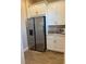 Pantry with stainless steel refrigerator and ample white cabinets for storage at 3219 Legends Preserve Dr, Daytona Beach, FL 32124