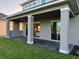 The covered patio has tiled flooring and sliding glass doors that provide indoor-outdoor living at 3219 Legends Preserve Dr, Daytona Beach, FL 32124