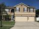 Charming two-story home with well-maintained landscaping, a two-car garage, and a welcoming front entrance at 466 Pepin Dr, Orlando, FL 32825