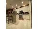 Modern kitchen features stainless steel appliances, a breakfast bar, and white cabinetry at 466 Pepin Dr, Orlando, FL 32825