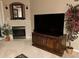 Cozy living room with a fireplace, built-in shelving, a large TV, and decorative plants at 466 Pepin Dr, Orlando, FL 32825