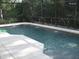 Sparkling pool with fountains enclosed by a screen, offering a private outdoor oasis at 466 Pepin Dr, Orlando, FL 32825