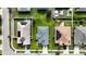 Aerial view of three houses with solar panels and green lawns at 1080 Condor Dr, Haines City, FL 33844