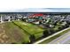 Aerial view showing community pool, playground, and large green space at 1080 Condor Dr, Haines City, FL 33844