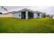 Spacious backyard with grassy lawn and screened-in patio at 1080 Condor Dr, Haines City, FL 33844