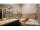 Bathroom with granite countertop, garden tub, and shower at 1080 Condor Dr, Haines City, FL 33844