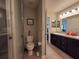 Bathroom with toilet, shower, and double vanity at 1080 Condor Dr, Haines City, FL 33844
