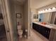 Bathroom with toilet, shower, and double vanity at 1080 Condor Dr, Haines City, FL 33844