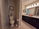 Bathroom with toilet, shower, and double vanity at 1080 Condor Dr, Haines City, FL 33844
