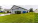Home exterior showing garage and driveway, plus landscaping at 1080 Condor Dr, Haines City, FL 33844