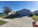 Single-story house with gray siding, attached garage, and landscaped yard at 1080 Condor Dr, Haines City, FL 33844