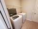 Washer and dryer in laundry room with shelving at 1080 Condor Dr, Haines City, FL 33844