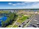 Wide aerial shot of a community park with a playground, lake, and a dog park bordered by homes at 14038 Scarlet Aster Aly, Winter Garden, FL 34787