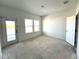 Bright living room featuring a door to the outside and ample natural light from the double windows at 14038 Scarlet Aster Aly, Winter Garden, FL 34787