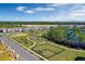 Aerial view of community amenities featuring a dog park, playground, walking trails, and a pond with neighborhood homes nearby at 14046 Scarlet Aster Aly, Winter Garden, FL 34787