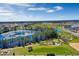 Aerial view of the community with a playground, walking paths, a scenic pond, and green spaces bordered by residential homes at 14046 Scarlet Aster Aly, Winter Garden, FL 34787