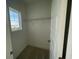 A bright, empty closet with a single shelf, carpeted floor and window at 14046 Scarlet Aster Aly, Winter Garden, FL 34787