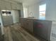 Kitchen island with sink and dishwasher and gray cabinetry at 14046 Scarlet Aster Aly, Winter Garden, FL 34787