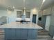 Modern kitchen with stainless steel appliances, granite countertops and gray cabinetry at 14046 Scarlet Aster Aly, Winter Garden, FL 34787